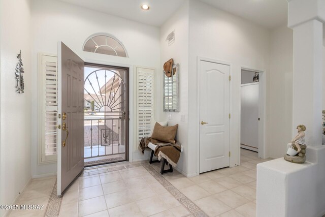 foyer entrance featuring light tile patterned flooring, baseboards, visible vents, and recessed lighting