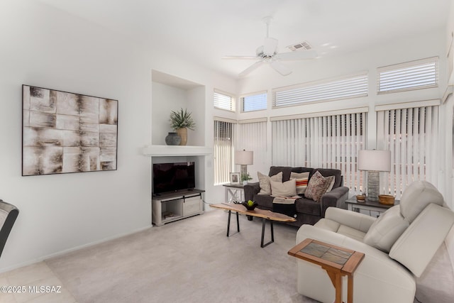 living area with a ceiling fan, light colored carpet, and visible vents