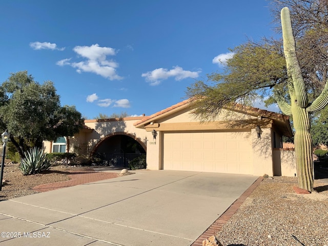 14420 N Del Webb Blvd, Oro Valley, AZ 85755 - view of front facade with stucco siding, an attached garage, driveway, and a tiled roof