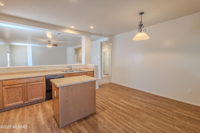 kitchen with a sink, black dishwasher, ceiling fan, light wood-type flooring, and light countertops