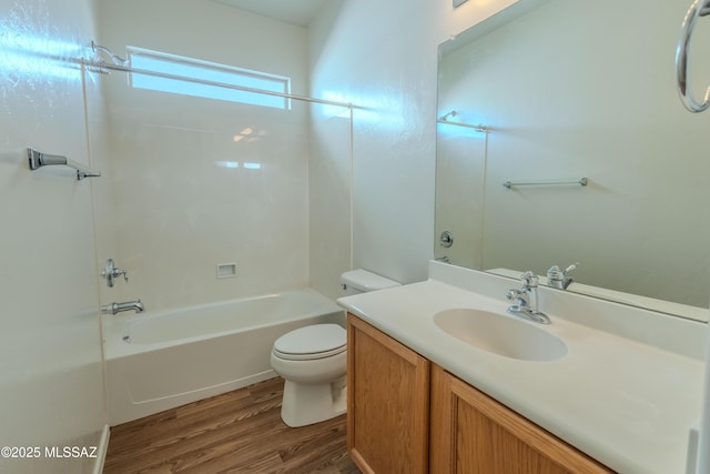 full bath with wood finished floors, toilet, vanity, and bathing tub / shower combination
