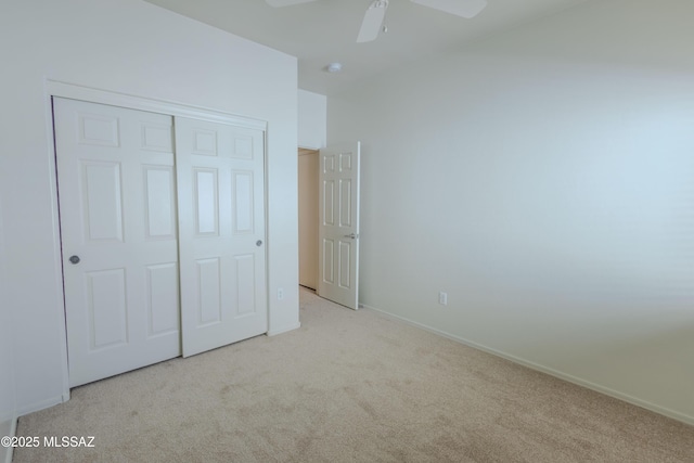 unfurnished bedroom with baseboards, a ceiling fan, a closet, and carpet