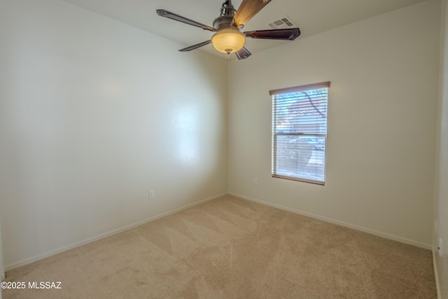 empty room featuring baseboards, visible vents, and light colored carpet