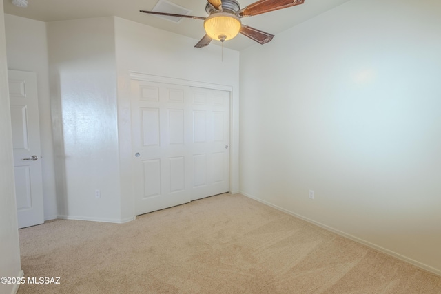 unfurnished bedroom with a closet, carpet flooring, a ceiling fan, and baseboards