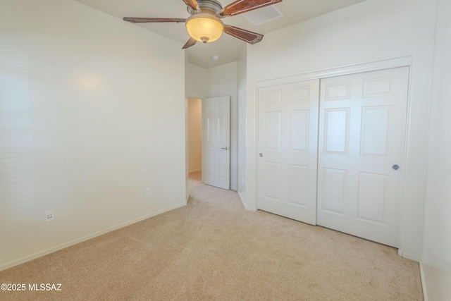 unfurnished bedroom with baseboards, ceiling fan, carpet floors, and a closet