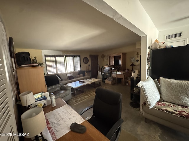 living room featuring lofted ceiling and visible vents