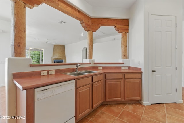 kitchen featuring visible vents, a sink, a fireplace, white dishwasher, and ceiling fan