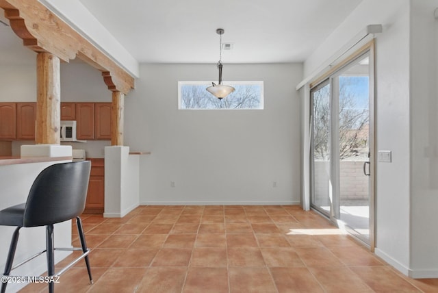 dining room with visible vents, decorative columns, light tile patterned flooring, and baseboards