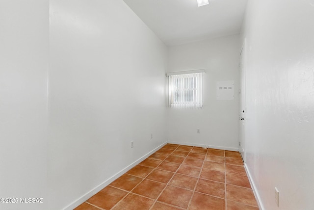 unfurnished room featuring light tile patterned flooring and baseboards