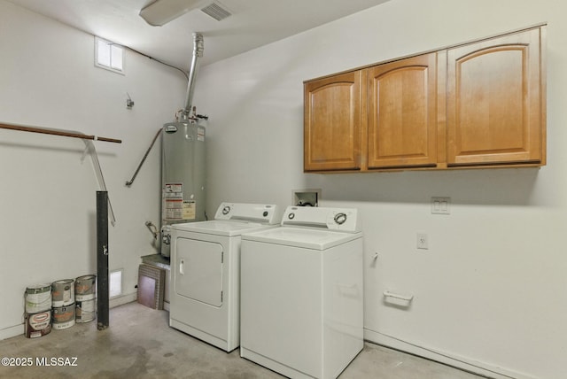 clothes washing area featuring water heater, washing machine and dryer, cabinet space, and visible vents
