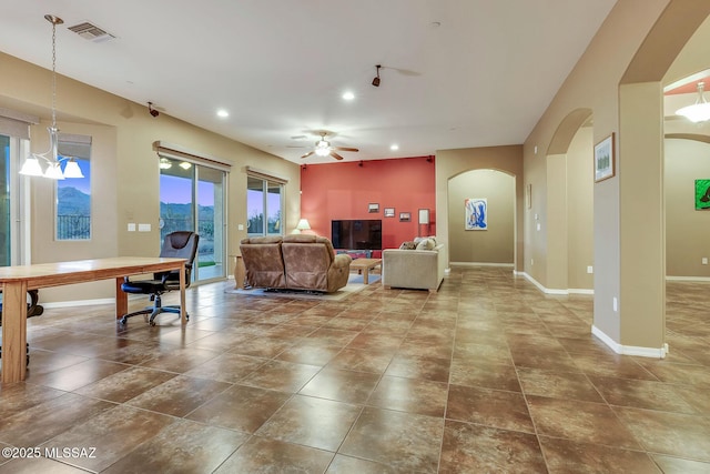 living room with baseboards, visible vents, arched walkways, ceiling fan, and recessed lighting