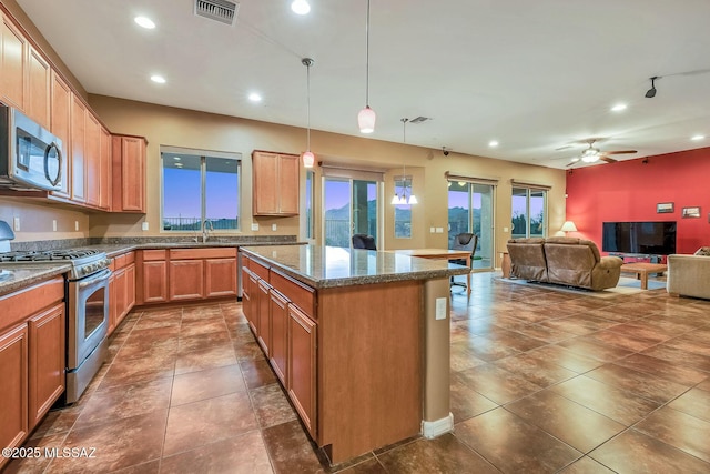 kitchen with visible vents, recessed lighting, a kitchen island, appliances with stainless steel finishes, and open floor plan
