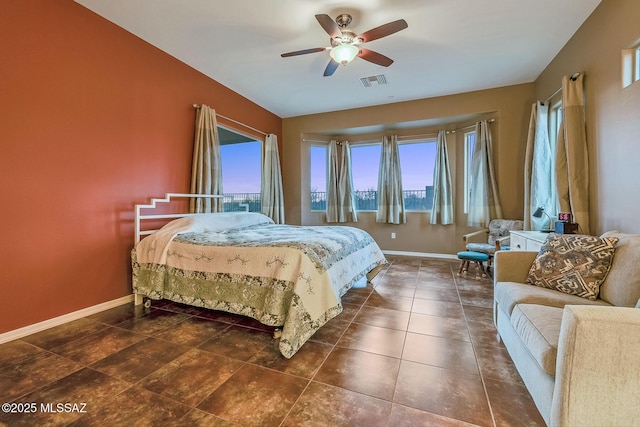 tiled bedroom featuring a ceiling fan, baseboards, multiple windows, and visible vents