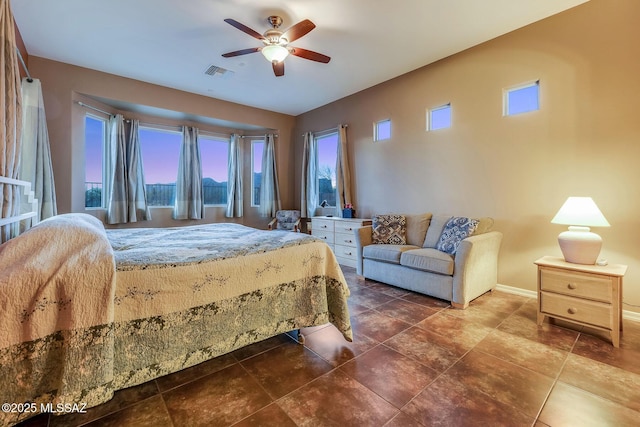 bedroom featuring a ceiling fan, baseboards, and visible vents