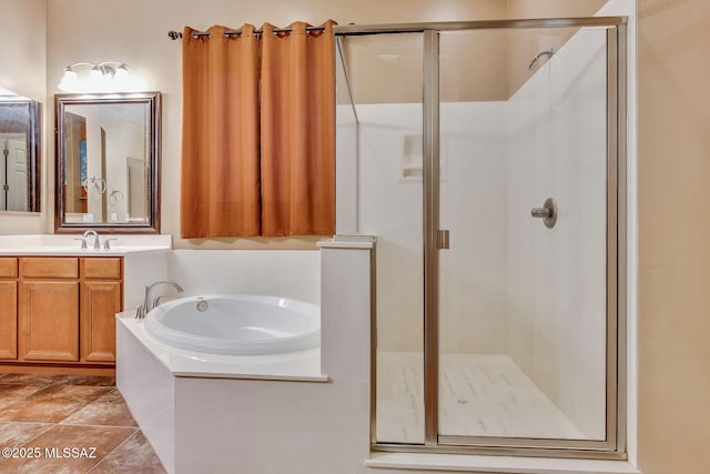 full bathroom with vanity, a bath, and a shower stall