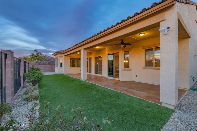 view of yard featuring a fenced backyard, a patio area, and a ceiling fan