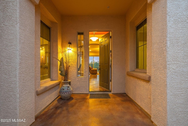 doorway to property with stucco siding and a patio area