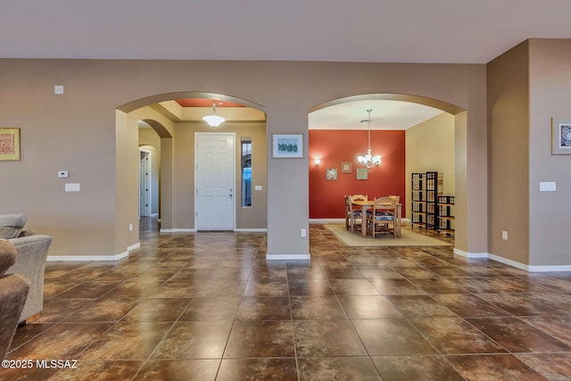 entryway with baseboards and dark tile patterned flooring
