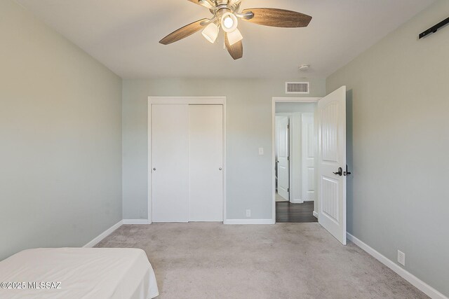 unfurnished bedroom featuring baseboards, visible vents, a closet, and carpet flooring