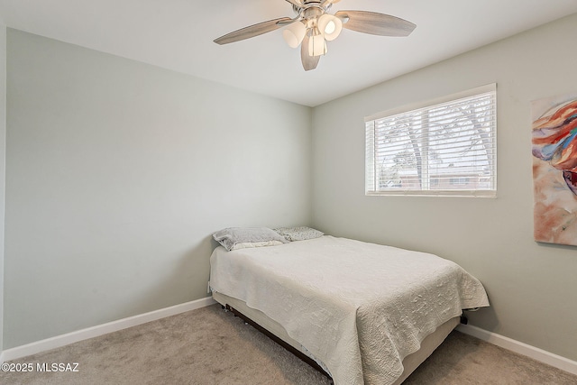 carpeted bedroom featuring baseboards and ceiling fan