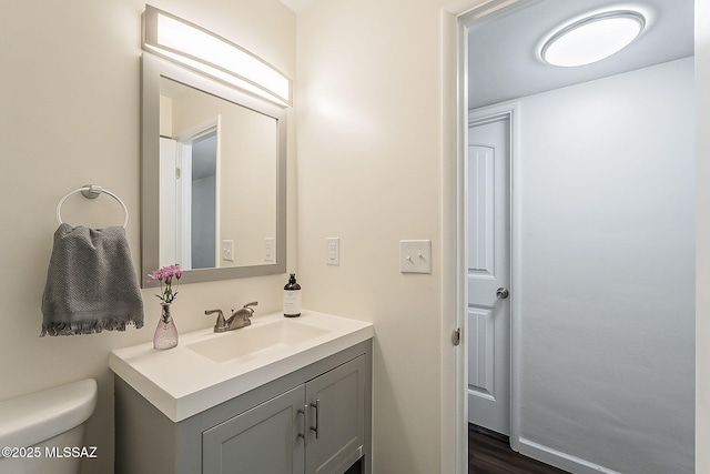 bathroom featuring toilet and vanity