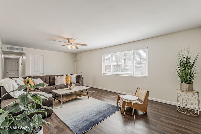 living room with a ceiling fan, visible vents, baseboards, and dark wood finished floors