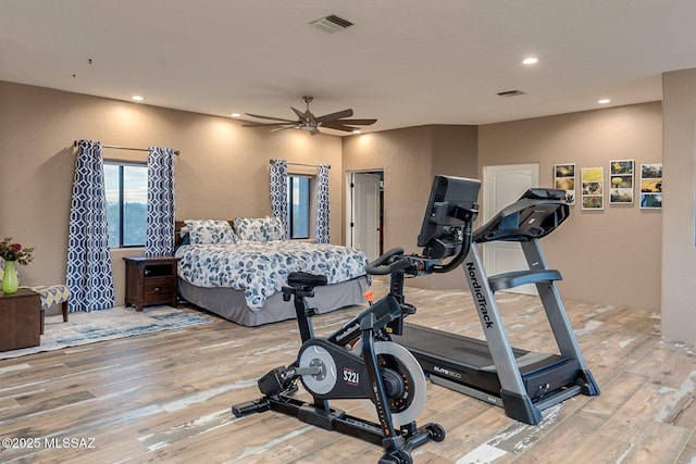 exercise room featuring recessed lighting, wood finished floors, visible vents, and ceiling fan