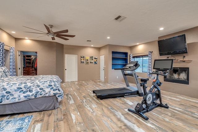 bedroom featuring recessed lighting, wood finished floors, visible vents, and ceiling fan