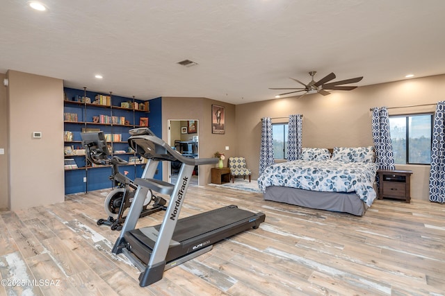 exercise room featuring visible vents, recessed lighting, a ceiling fan, and wood finished floors