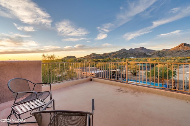 view of patio / terrace with a mountain view and a balcony