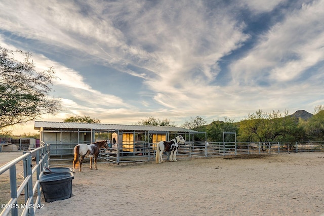 view of stable with a rural view