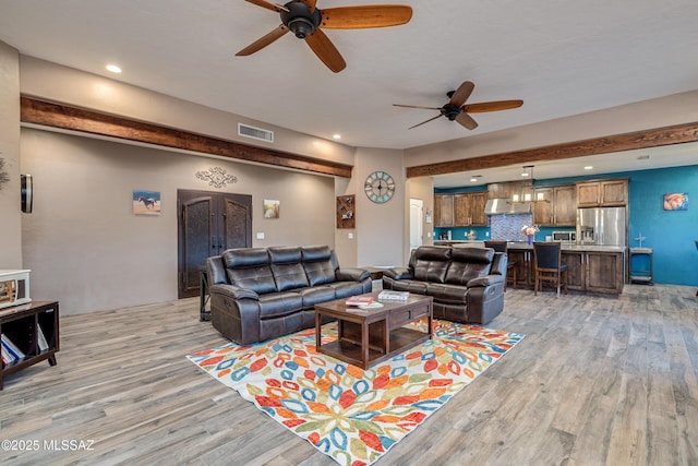 living area with recessed lighting, visible vents, ceiling fan, and light wood-style flooring
