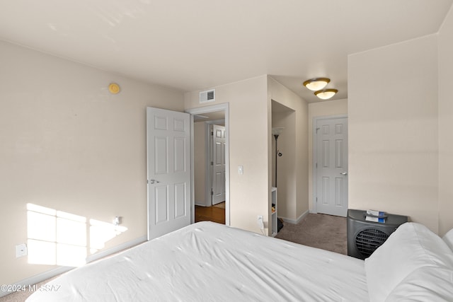 bedroom with visible vents, baseboards, and carpet