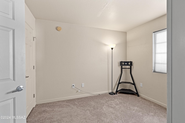 unfurnished room featuring baseboards and carpet floors