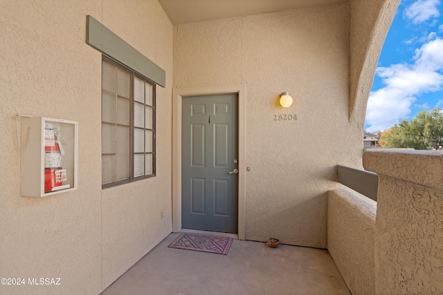 view of exterior entry with stucco siding