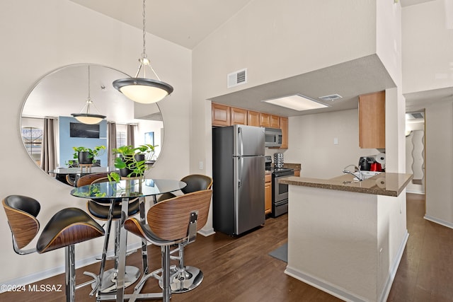 kitchen with dark wood finished floors, visible vents, appliances with stainless steel finishes, and high vaulted ceiling