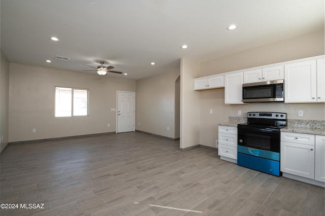 kitchen with a ceiling fan, visible vents, baseboards, stainless steel microwave, and black range with electric cooktop
