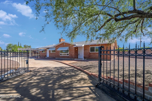 2350 E Juanita St, Tucson, AZ 85719 - single story home with brick siding, a gate, concrete driveway, and fence