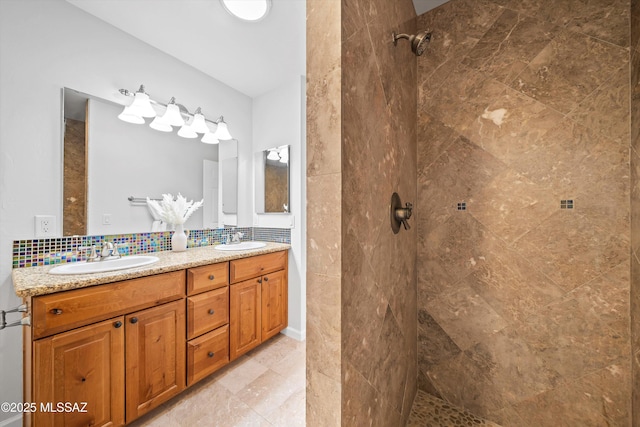 2350 E Juanita St, Tucson, AZ 85719 - bathroom with a tile shower, double vanity, and tasteful backsplash