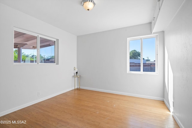 2350 E Juanita St, Tucson, AZ 85719 - spare room featuring plenty of natural light, light wood-type flooring, and baseboards