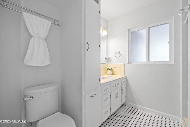 2350 E Juanita St, Tucson, AZ 85719 - bathroom with toilet, tile patterned floors, vanity, baseboards, and decorative backsplash