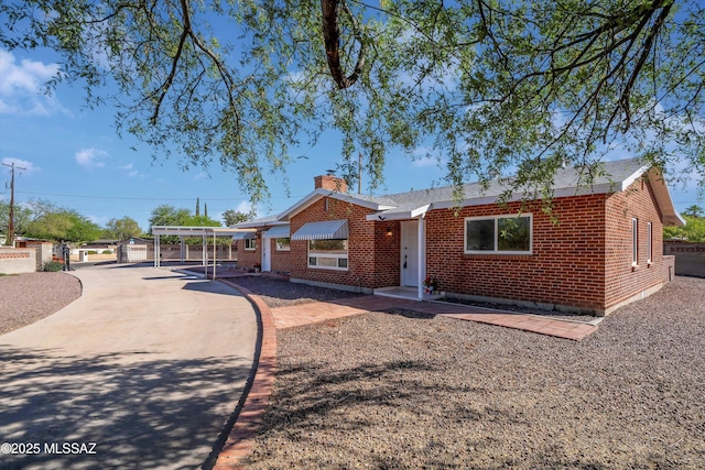 2350 E Juanita St, Tucson, AZ 85719 - ranch-style home featuring brick siding, a chimney, and fence