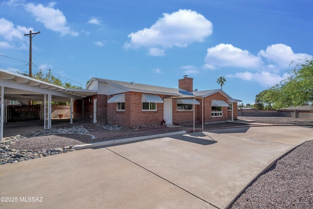 2350 E Juanita St, Tucson, AZ 85719 - rear view of house featuring brick siding, fence, and a chimney