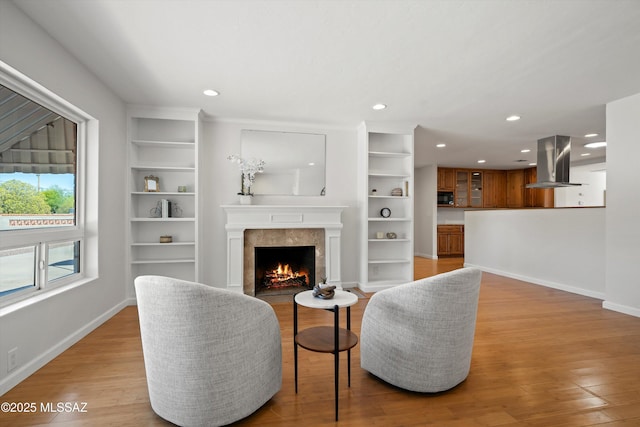 2350 E Juanita St, Tucson, AZ 85719 - living room featuring recessed lighting, light wood-style flooring, built in shelves, baseboards, and a high end fireplace