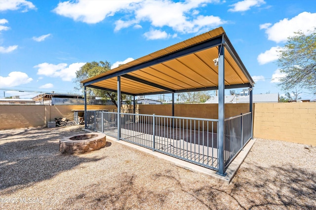 view of patio featuring a fenced backyard and an outdoor fire pit