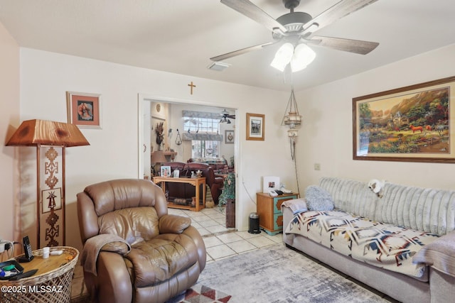 living room featuring a ceiling fan, light tile patterned flooring, and visible vents