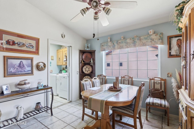 dining space with vaulted ceiling, washer and dryer, ceiling fan, and light tile patterned floors