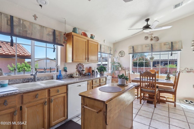 kitchen with a sink, a ceiling fan, lofted ceiling, white dishwasher, and visible vents
