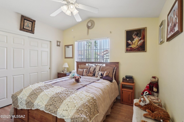 bedroom featuring a closet, lofted ceiling, ceiling fan, and wood finished floors