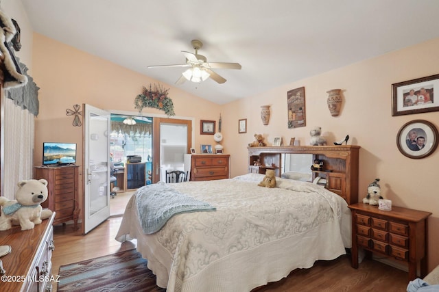 bedroom with access to exterior, wood finished floors, vaulted ceiling, and a ceiling fan